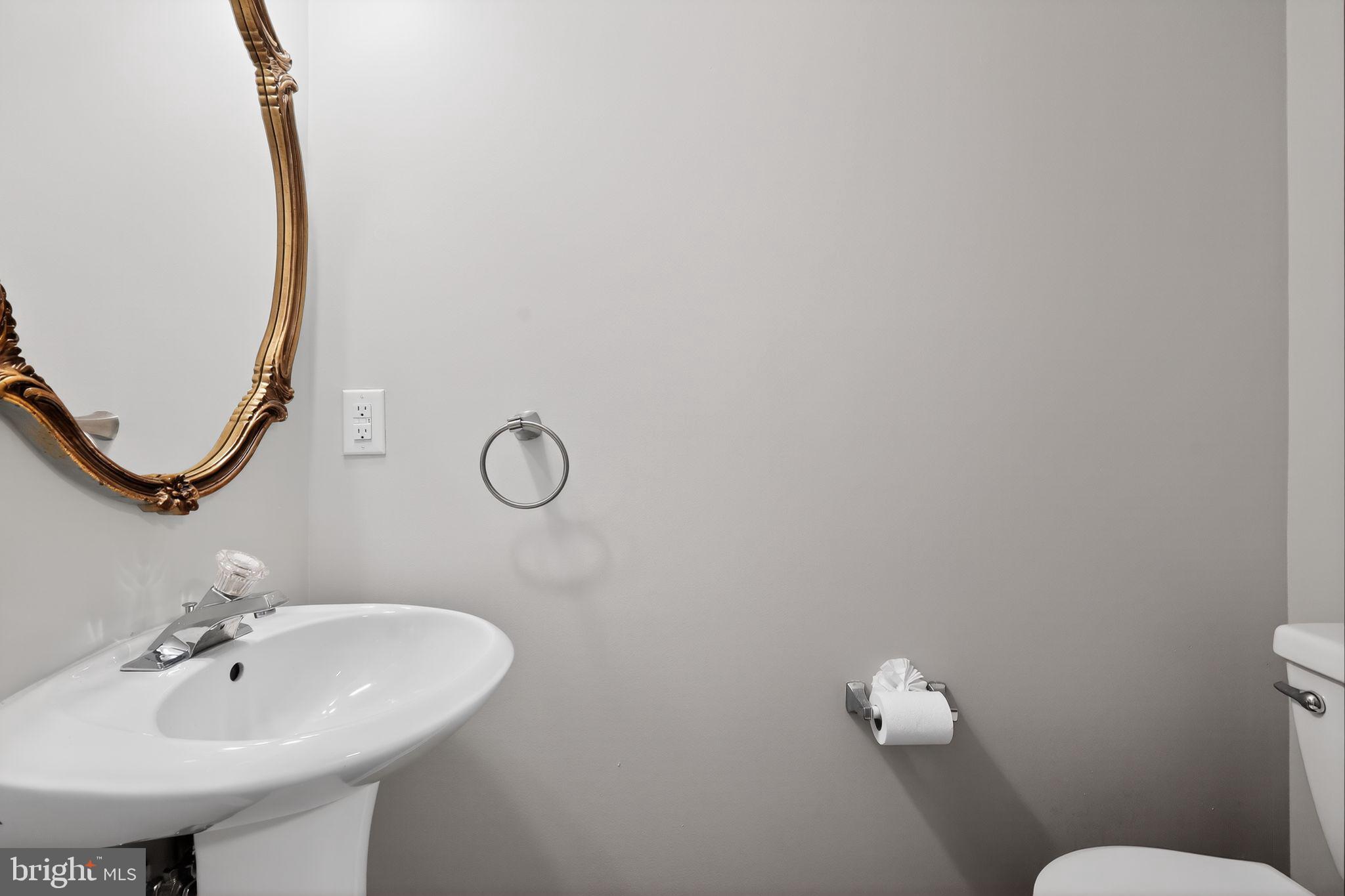 18707 Little Star Lane Germantown, MD 20874 - Photo 23 of 30 a bathroom with a sink a toilet and a mirror