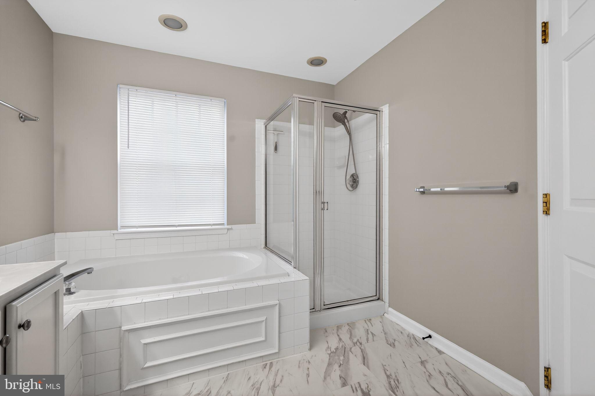 18707 Little Star Lane Germantown, MD 20874 - Photo 24 of 30 a bathroom with a bathtub and a shower