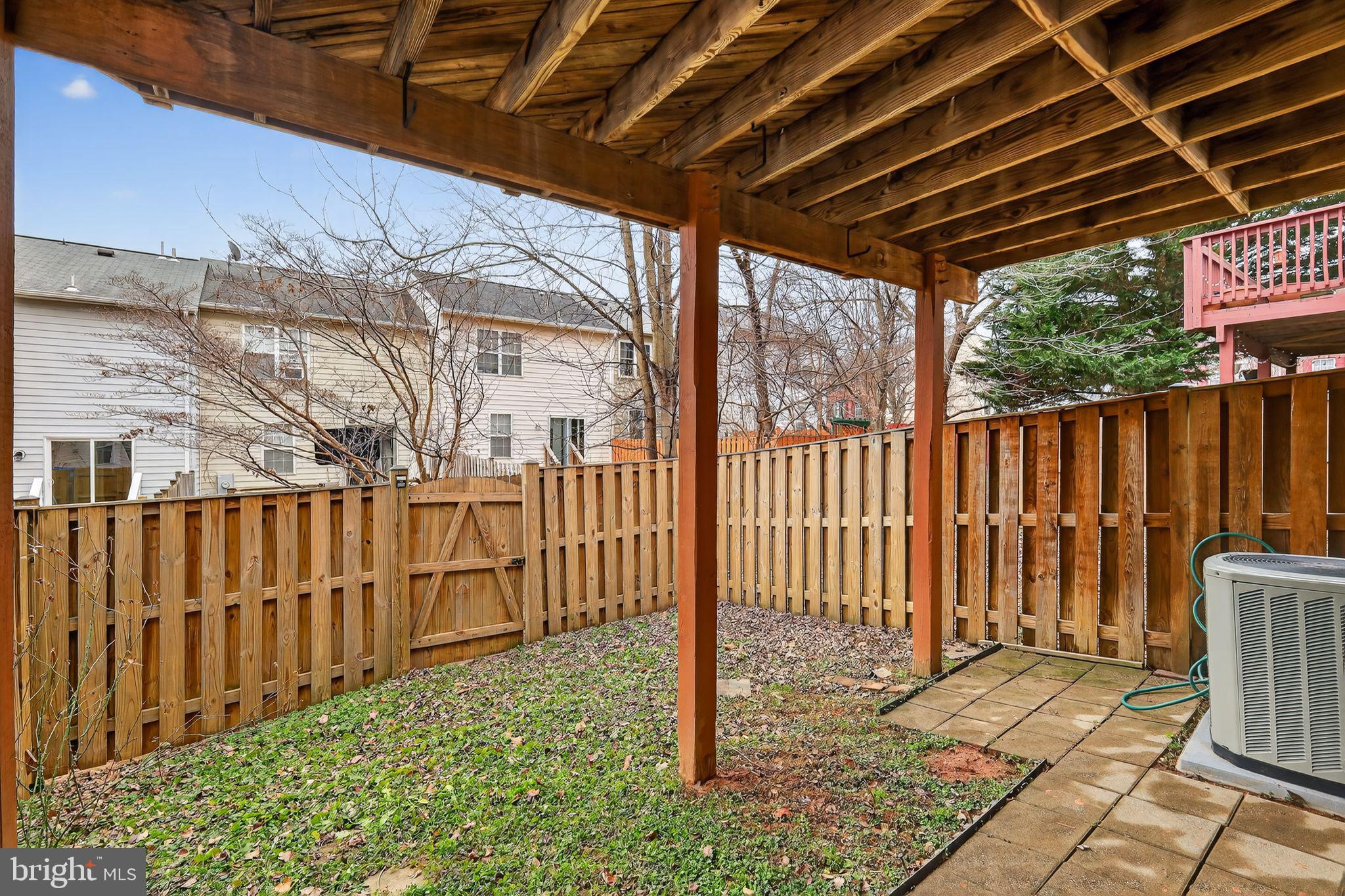 18707 Little Star Lane Germantown, MD 20874 - Photo 28 of 30 a view of a backyard with wooden fence