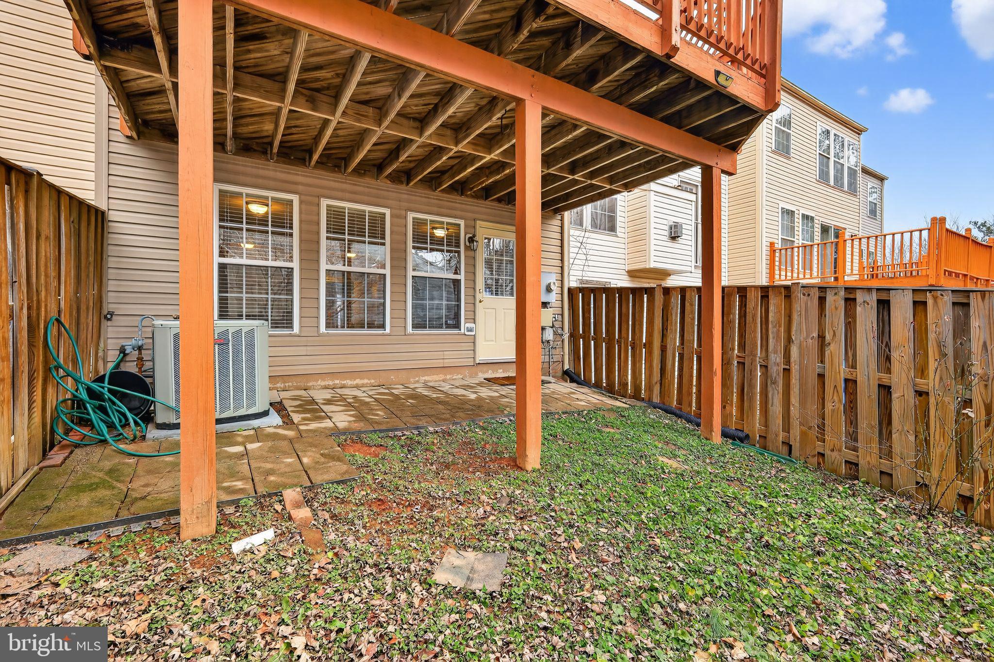 18707 Little Star Lane Germantown, MD 20874 - Photo 29 of 30 a porch with a table and chairs in front of a house
