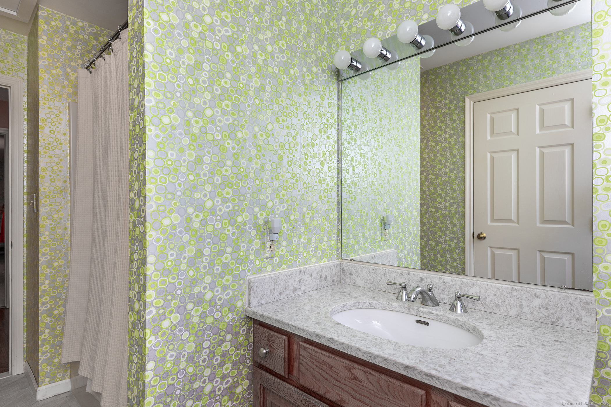 29 Quarry Ridge Road, Unit 29 Washington, CT 06777 - Photo 14 of 19 a bathroom with a granite countertop sink a mirror and shower