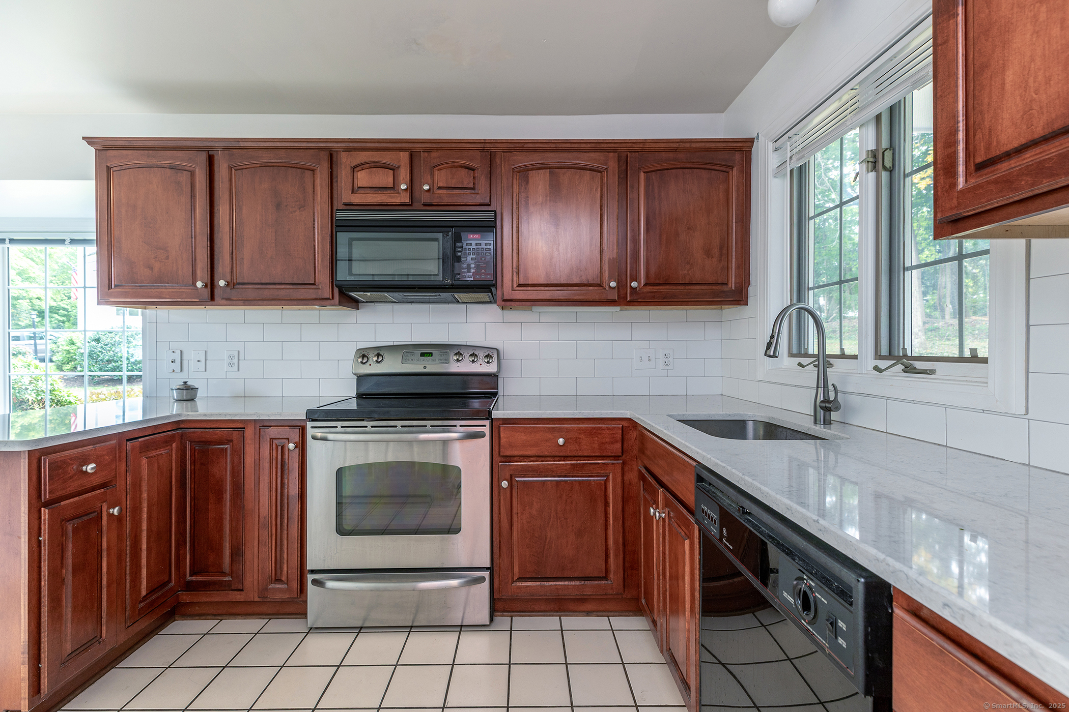 29 Quarry Ridge Road, Unit 29 Washington, CT 06777 - Photo 3 of 19 a kitchen with granite countertop a sink stove and cabinets