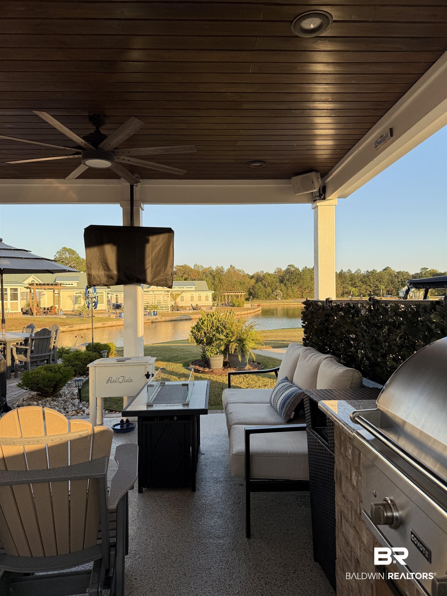 28238 Migratory Way Elberta, AL 36530 - Photo 14 of 58 View of patio / terrace with outdoor lounge area, a water view, a ceiling fan, and exterior kitchen