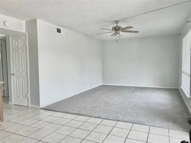 a view of a livingroom with a ceiling fan and window