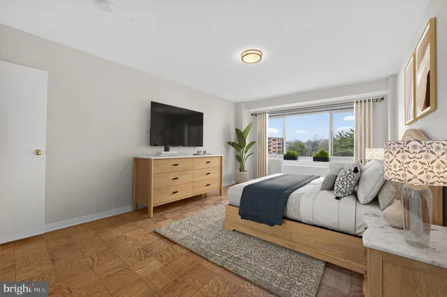 a bedroom with furniture and flat screen tv