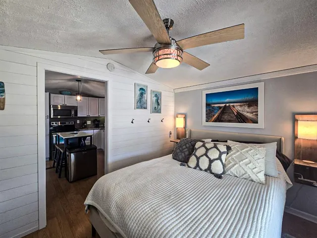 a bedroom with a large bed and a window