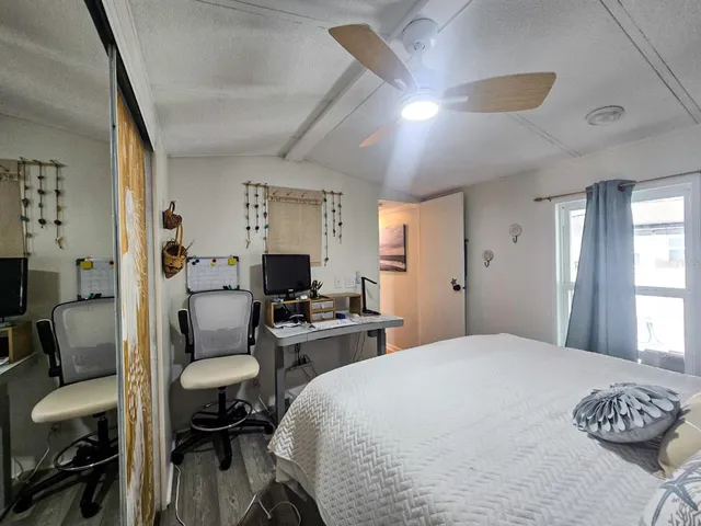 a bedroom with a bed and a chair