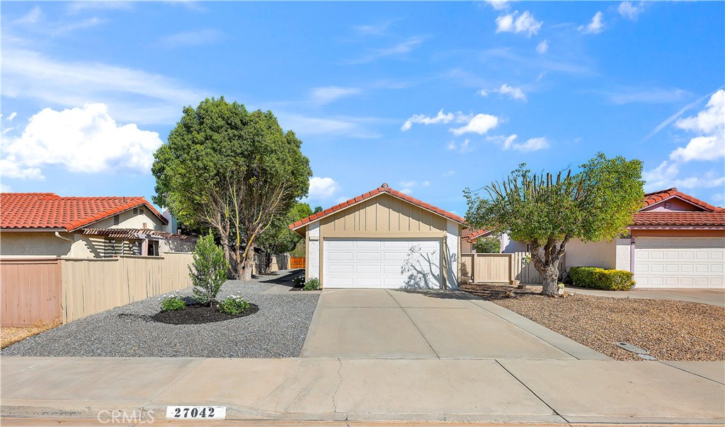 27042 Rangewood Street Menifee, CA 92586 - Photo 1 of 1 a front view of a house with a yard and garage