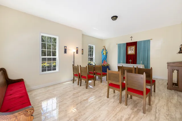 a spacious bedroom with a bed and a desk