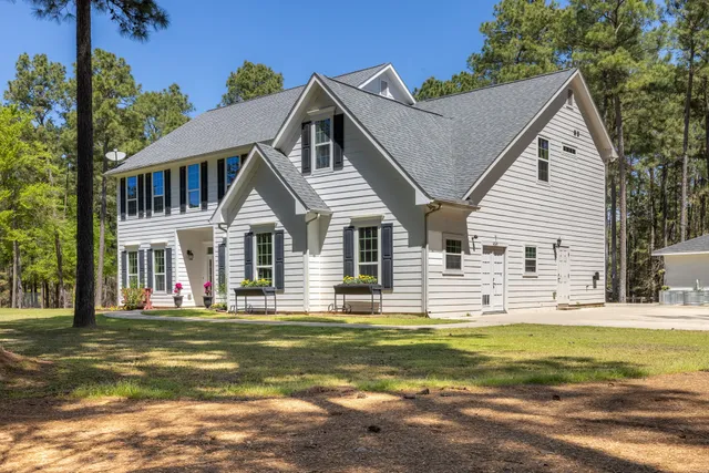 a front view of house with outdoor seating and yard