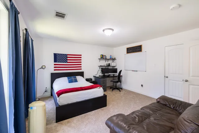 a bedroom with a bed and gym equipment