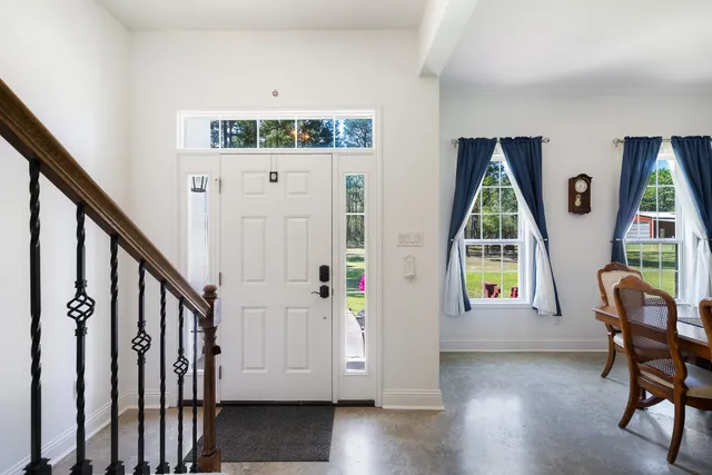a view of an entryway with wooden floor and windows