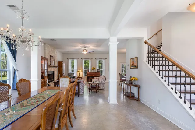 a dining room with furniture entryway and wooden floor