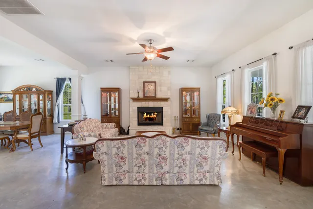 a living room with furniture fireplace and window