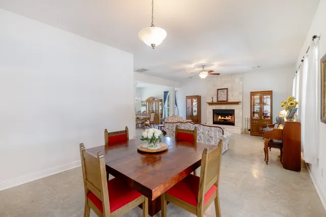 a view of a dining room with furniture and a chandelier fan