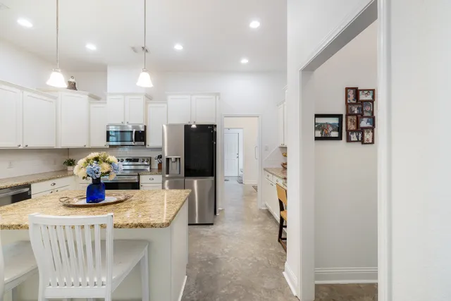 a kitchen with a refrigerator and a stove top oven