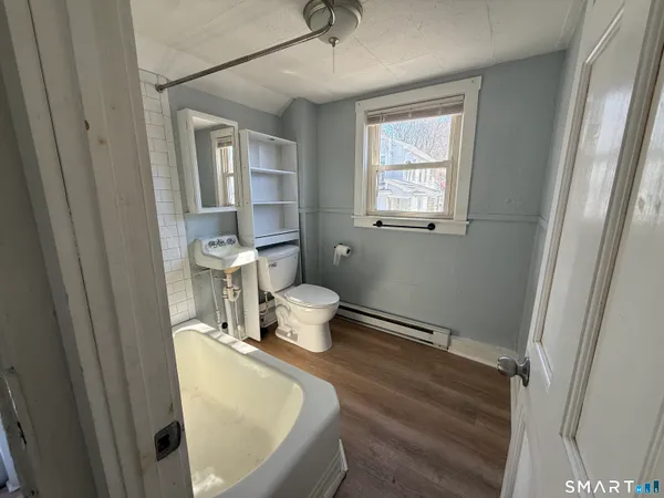 a kitchen with granite countertop a sink stove top oven and refrigerator