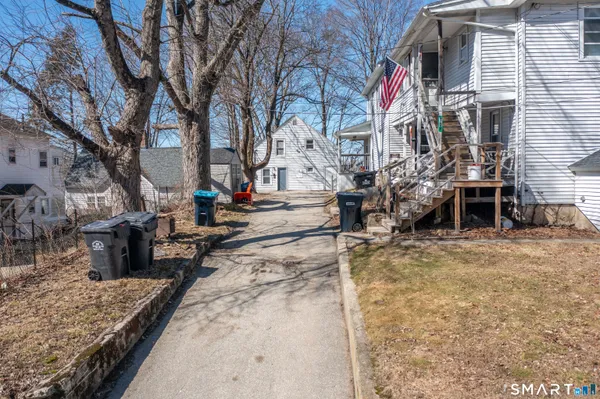 a view of a backyard with snow on the road