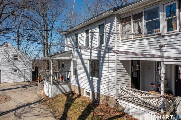 a view of a house with backyard and porch