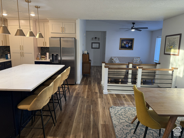 175 North 160 East Hurricane, UT 84737 - Photo 16 of 43 Dining space with a textured ceiling, dark wood-style floors, and a ceiling fan
