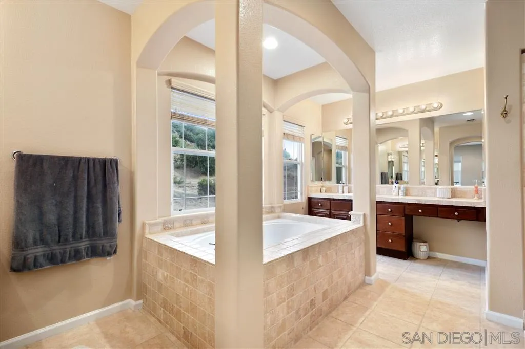 8403 Watson Ranch Road San Diego, CA 92129 - Photo 16 of 25 a large bathroom with a tub and shower