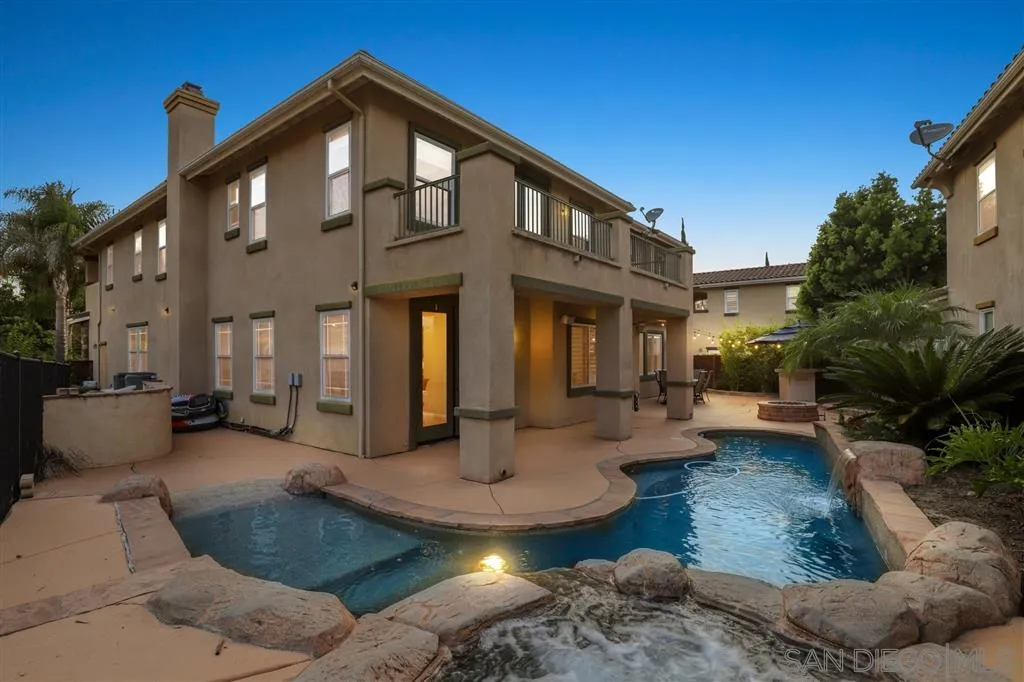 8403 Watson Ranch Road San Diego, CA 92129 - Photo 2 of 25 a front view of a house with swimming pool and porch