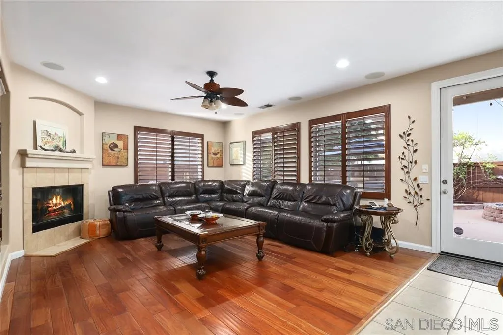 8403 Watson Ranch Road San Diego, CA 92129 - Photo 4 of 25 a living room with furniture and a fireplace