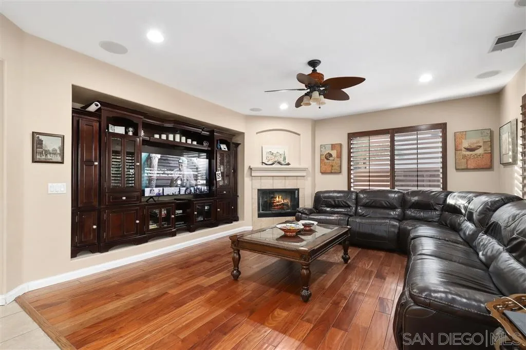 8403 Watson Ranch Road San Diego, CA 92129 - Photo 5 of 25 a living room with furniture a flat screen tv and a fireplace