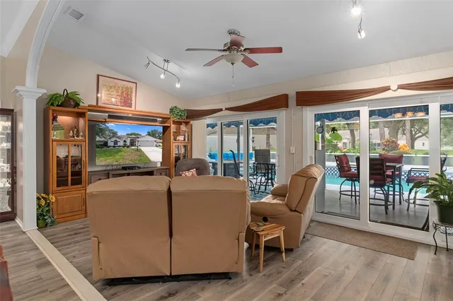 a kitchen with stainless steel appliances granite countertop a sink refrigerator and cabinets
