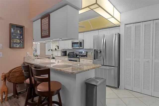 a kitchen with stainless steel appliances granite countertop a sink and cabinets