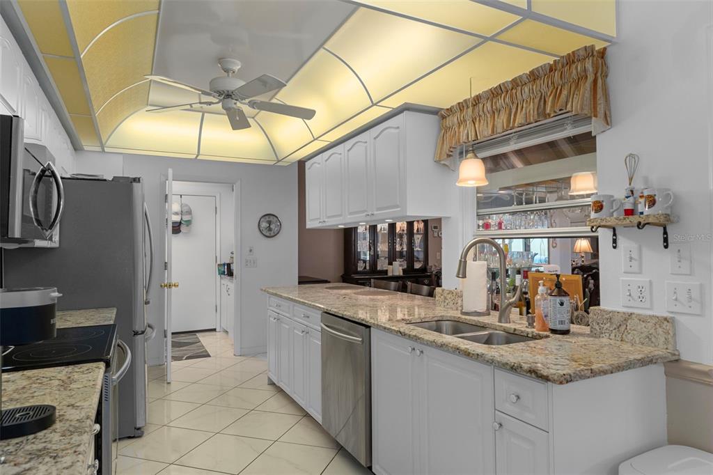 2345 Terrace View Lane Spring Hill, FL 34606 - Photo 20 of 95 a kitchen with stainless steel appliances granite countertop a sink and cabinets