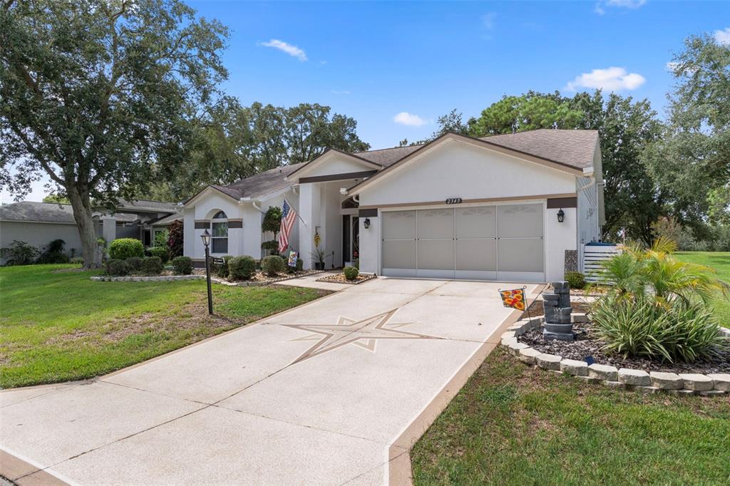 2345 Terrace View Lane Spring Hill, FL 34606 - Photo 3 of 95 a view of a white house with a yard and potted plants