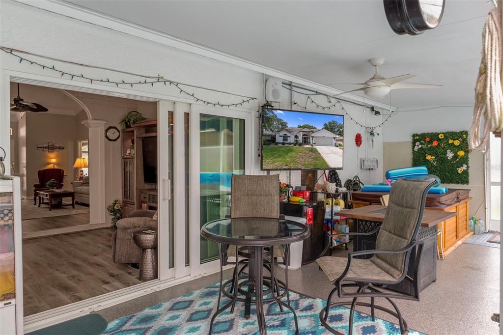 2345 Terrace View Lane Spring Hill, FL 34606 - Photo 38 of 95 a view of a dining room with furniture one side kitchen view and a chandelier
