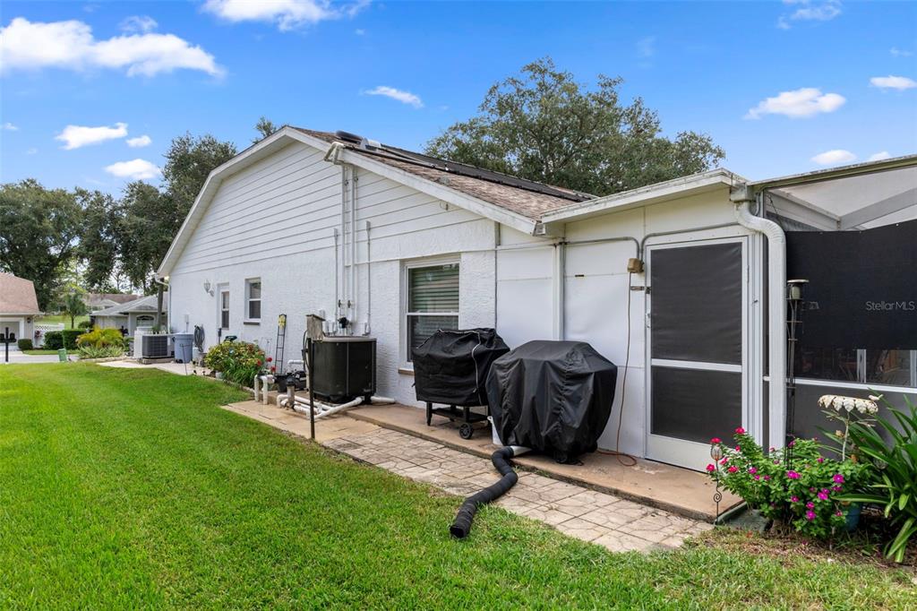 2345 Terrace View Lane Spring Hill, FL 34606 - Photo 47 of 95 a view of a backyard with furniture and a grill