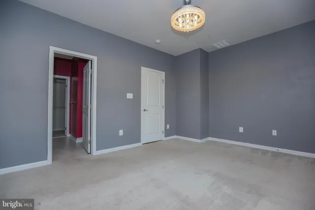 a view of an empty room with a door