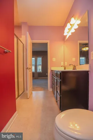 a bathroom with a toilet a sink and mirror
