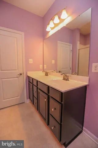 a bathroom with a sink vanity and mirror