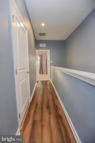 a view of gallery with wooden floor