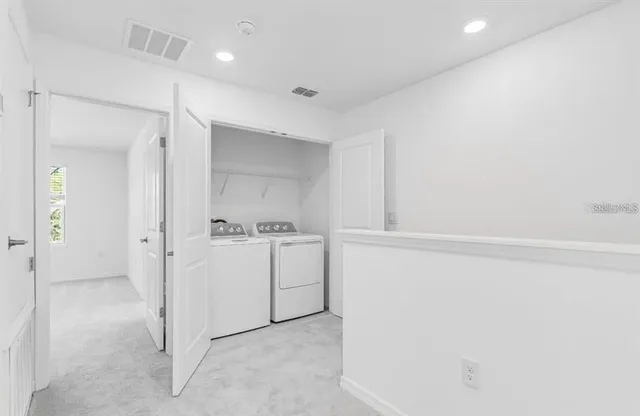 swimming pool with large trees and a wooden fence