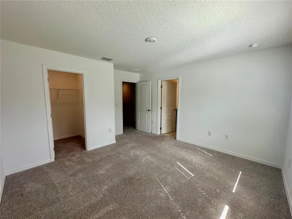 a bedroom with bed and a dresser