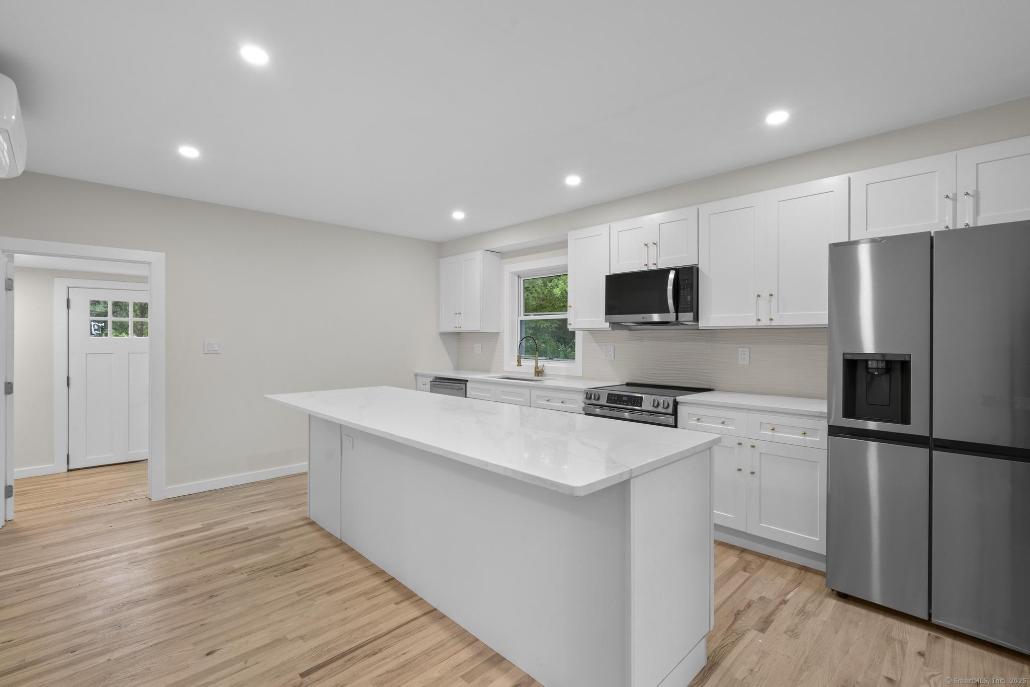 123 Lower Road North Canaan, CT 06024 - Photo 3 of 38 a kitchen with a refrigerator stove and wooden cabinets