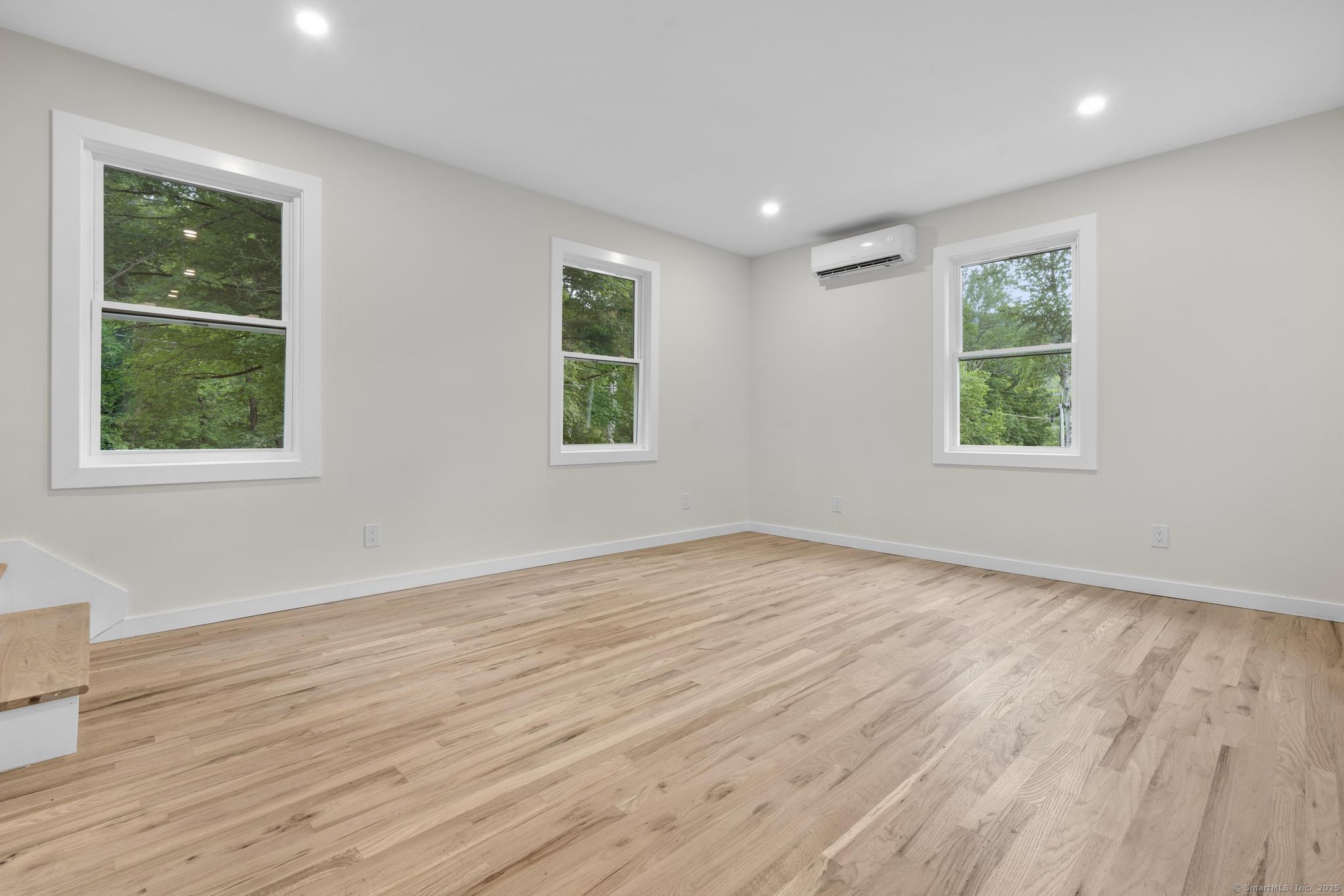 123 Lower Road North Canaan, CT 06024 - Photo 7 of 38 a view of an empty room with wooden floor and a window
