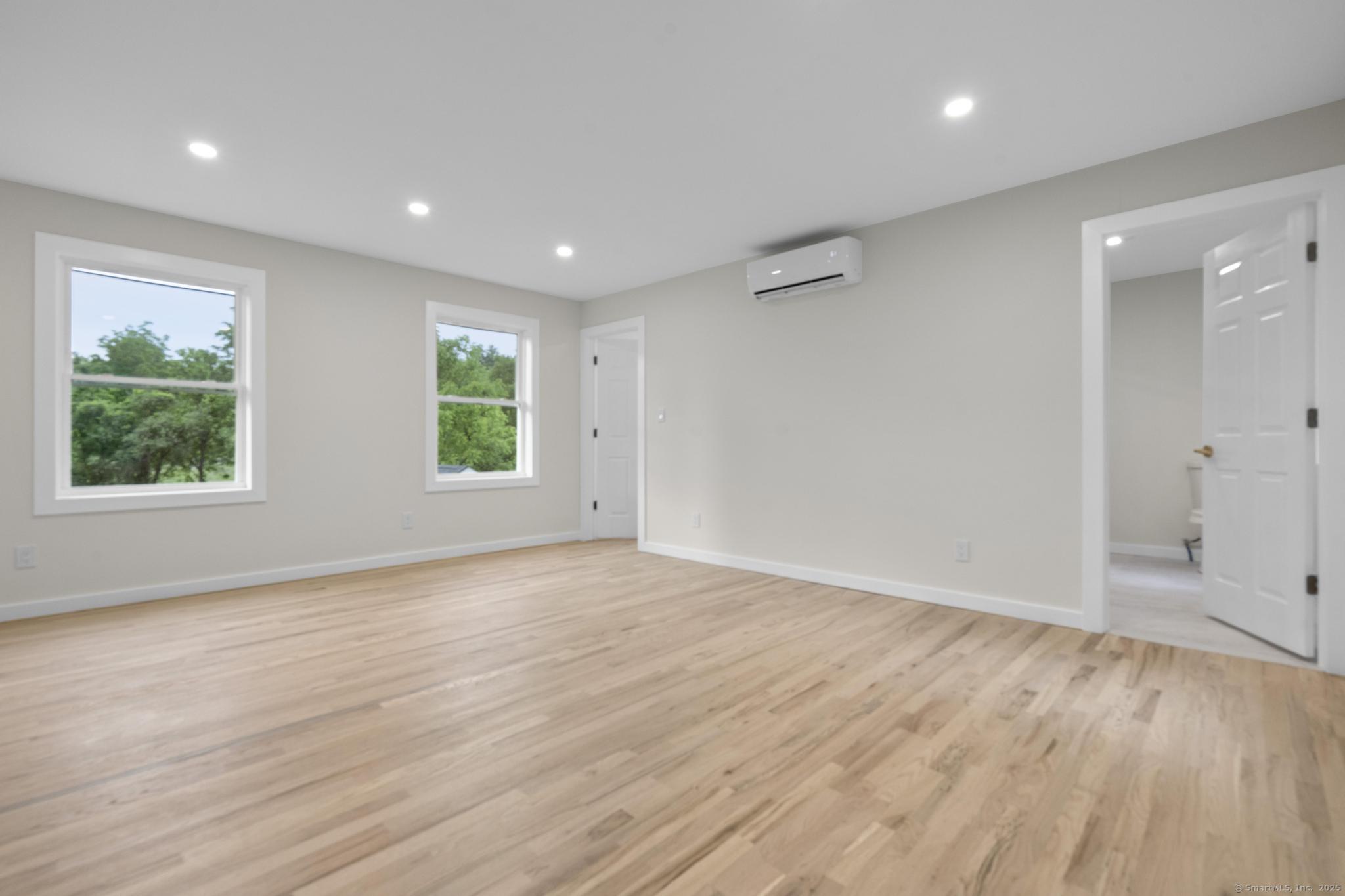 123 Lower Road North Canaan, CT 06024 - Photo 9 of 38 an empty room with wooden floor and windows