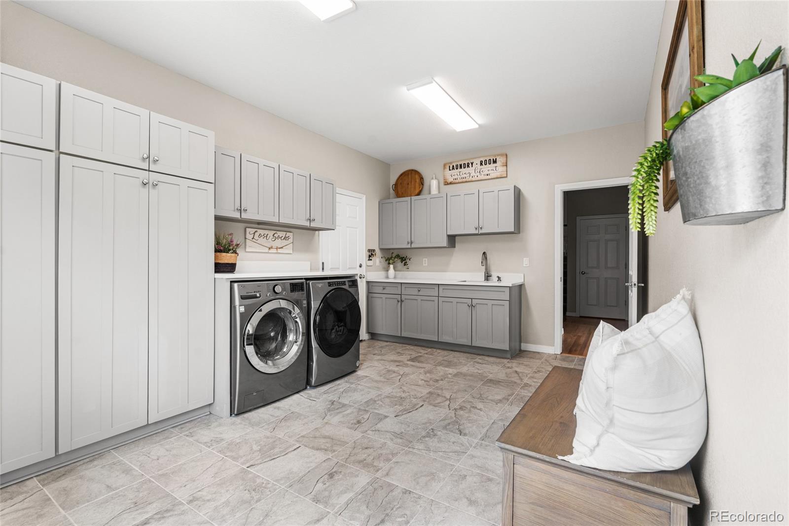 11041 Puma Run Lone Tree, CO 80124 - Photo 11 of 35 a utility room with cabinets washer and dryer