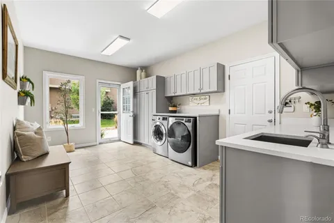 a utility room with sink dryer and washer