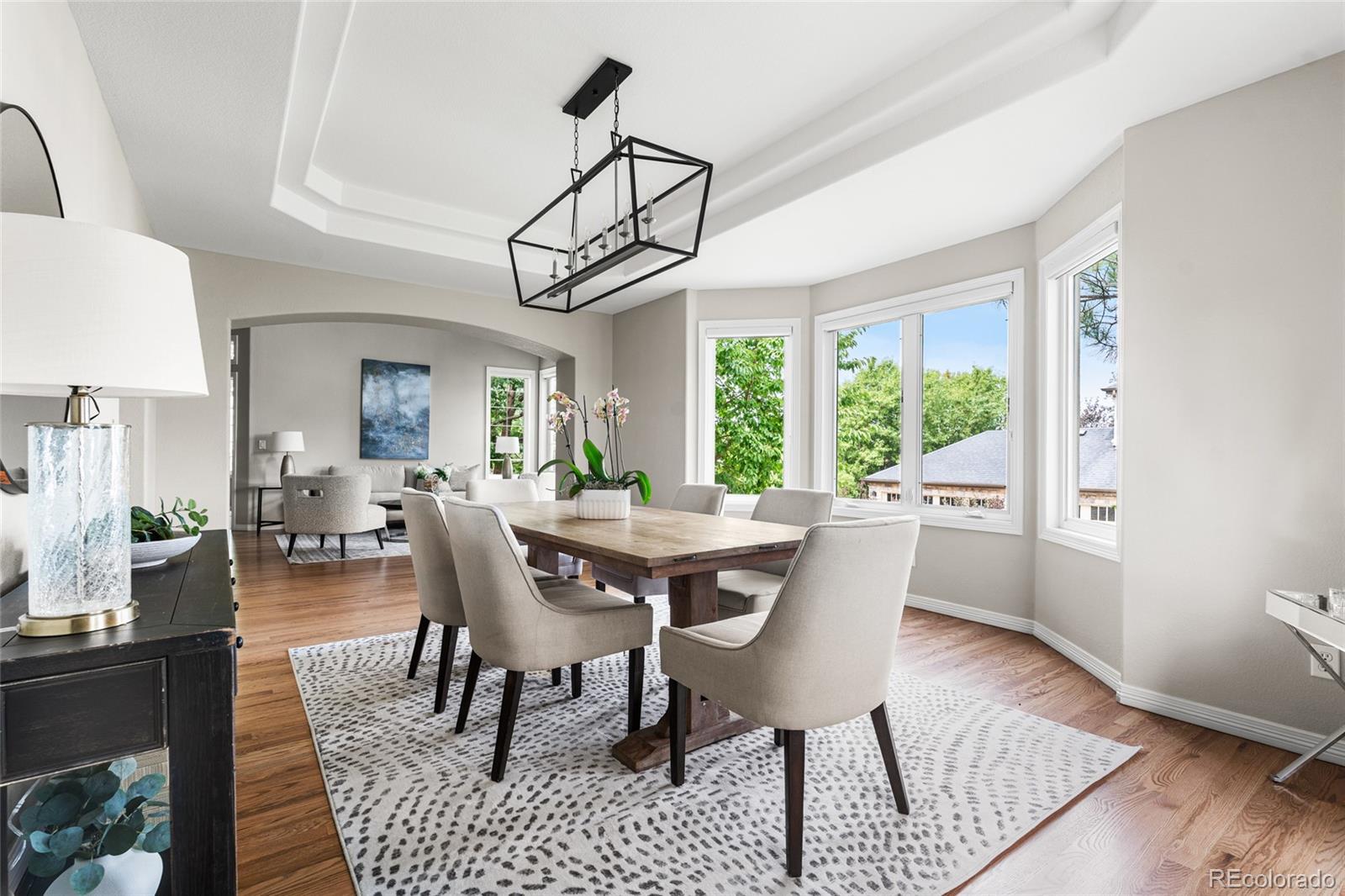 11041 Puma Run Lone Tree, CO 80124 - Photo 14 of 35 a dining room with furniture a chandelier and wooden floor