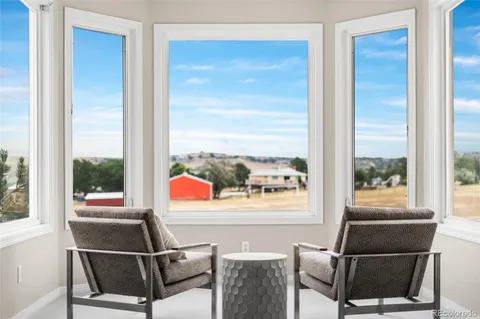 a living room with a couch and a floor to ceiling window