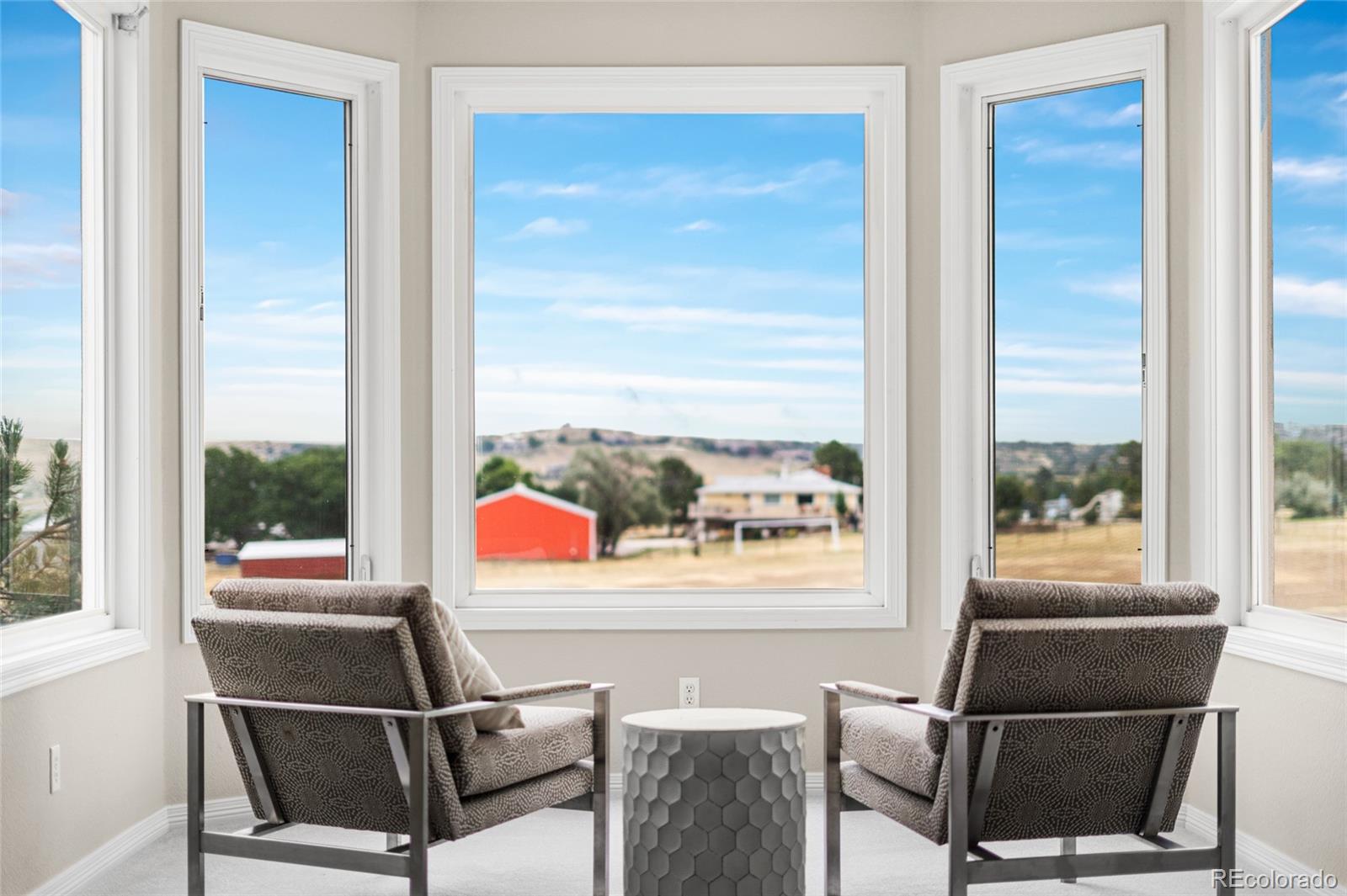 11041 Puma Run Lone Tree, CO 80124 - Photo 16 of 35 a living room with a couch and a floor to ceiling window