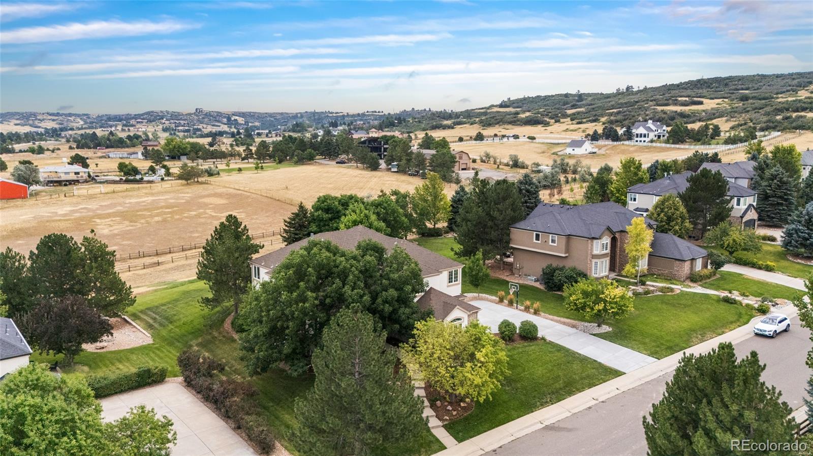 11041 Puma Run Lone Tree, CO 80124 - Photo 2 of 35 an aerial view of a city with lots of residential buildings ocean and mountain view in back