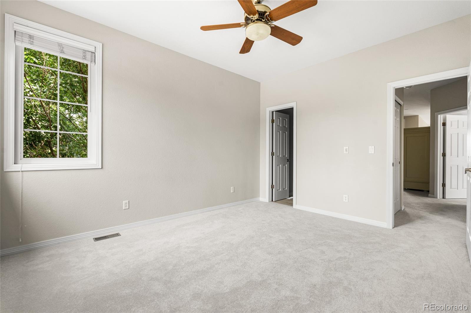 11041 Puma Run Lone Tree, CO 80124 - Photo 23 of 35 an empty room with a window and a fan